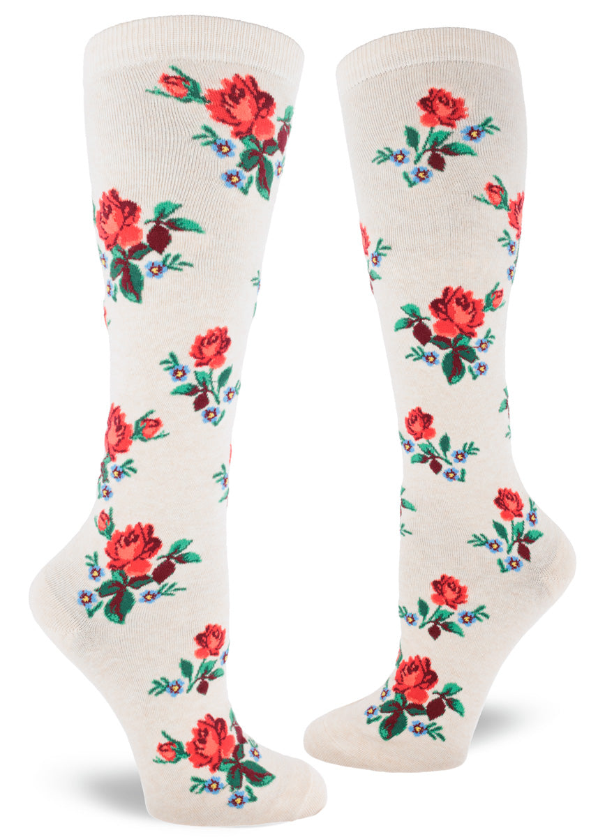 Cream knee socks with red roses and blue floral accents in an allover pattern.