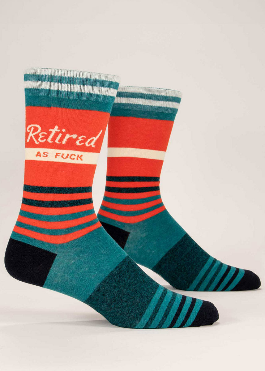 Men&#39;s crew socks with the words &quot;Retired as Fuck&quot; over a teal, orange, and white striped background.