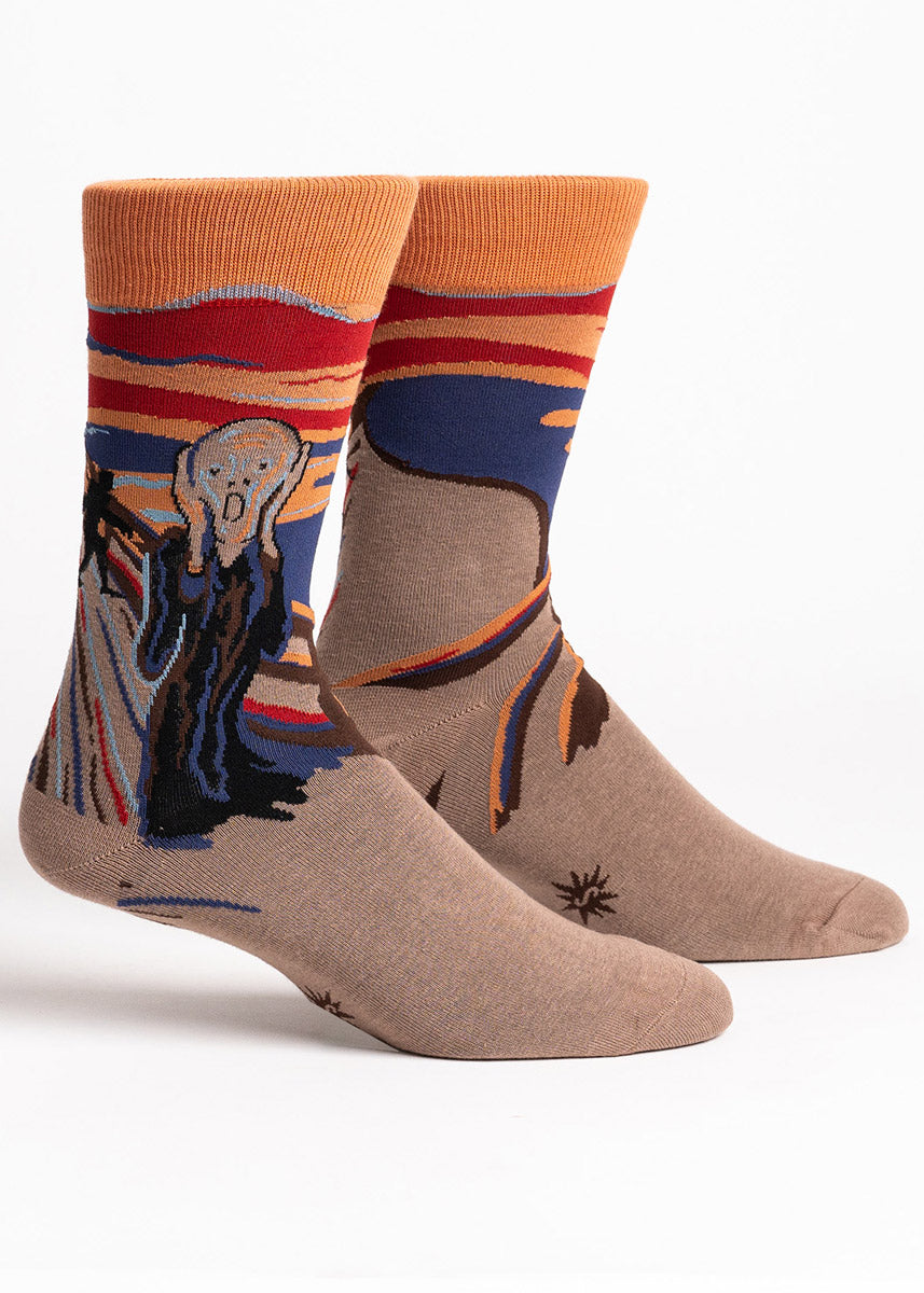 Brown, orange, and navy crew socks for men feature a design of the &quot;The Scream&quot; painting by Edvard Munch but with a black Bigfoot silhouette in the background behind the screaming figure.