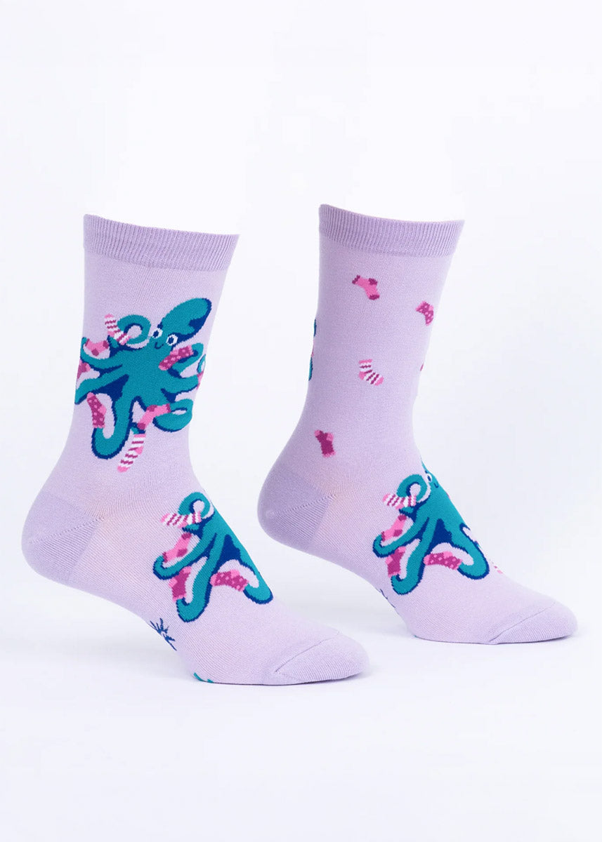 Pair of light purple women's crew socks with a sock-wearing octopus design on a white background.