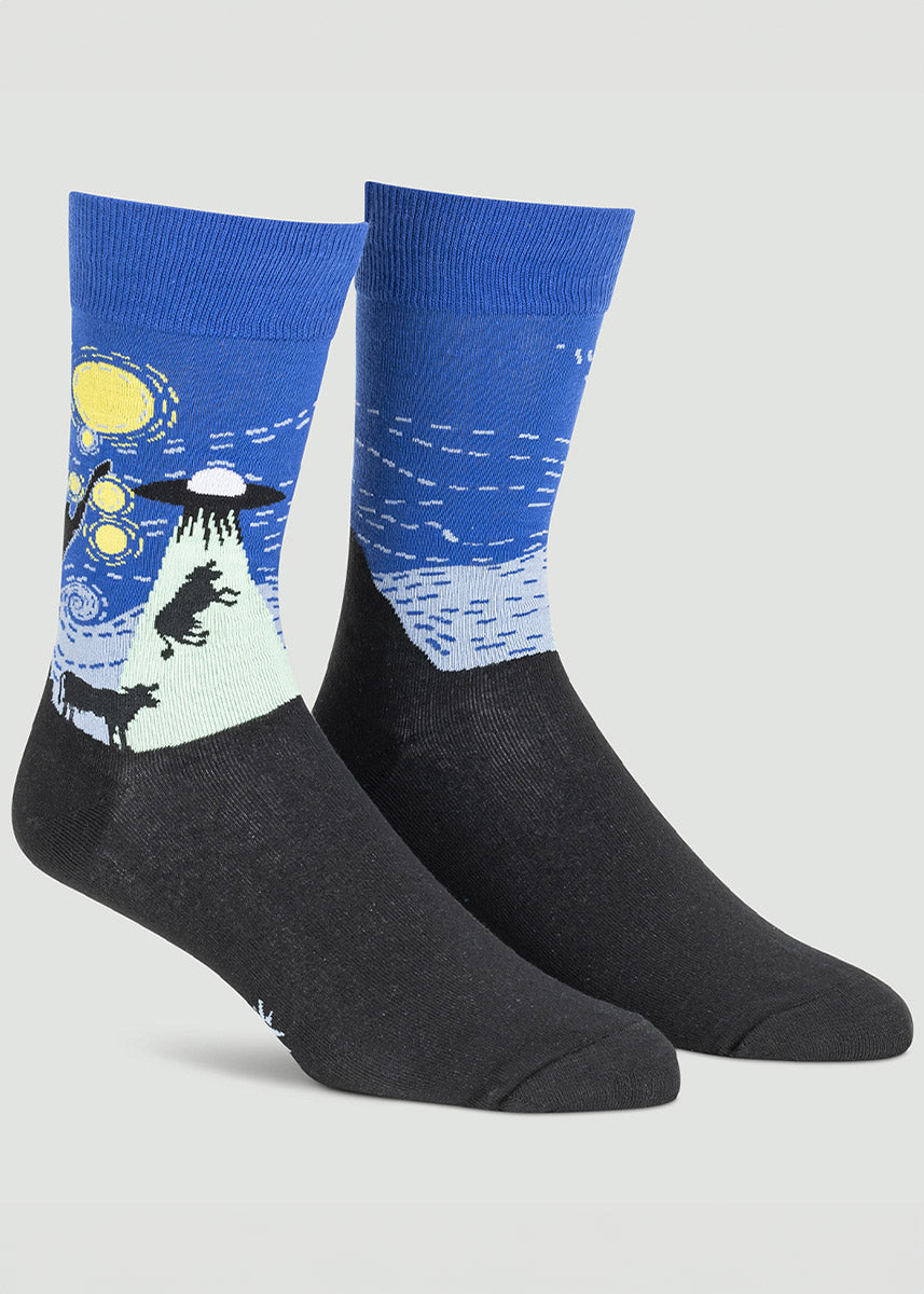 Royal blue and black novelty crew socks for men feature a Starry Night parody that includes a UFO lifting a cow into the sky in Van Gogh&#39;s signature art style.