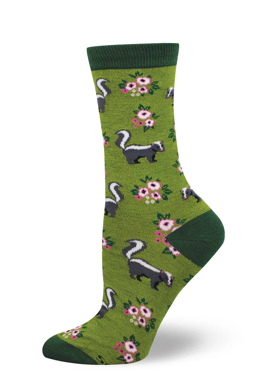 Green sock with skunk and floral pattern on a white background.