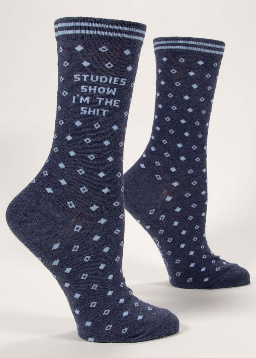 Navy crew socks for women with an allover light blue diamond pattern and the words "Studies Show I'm the Shit" knit into the leg.