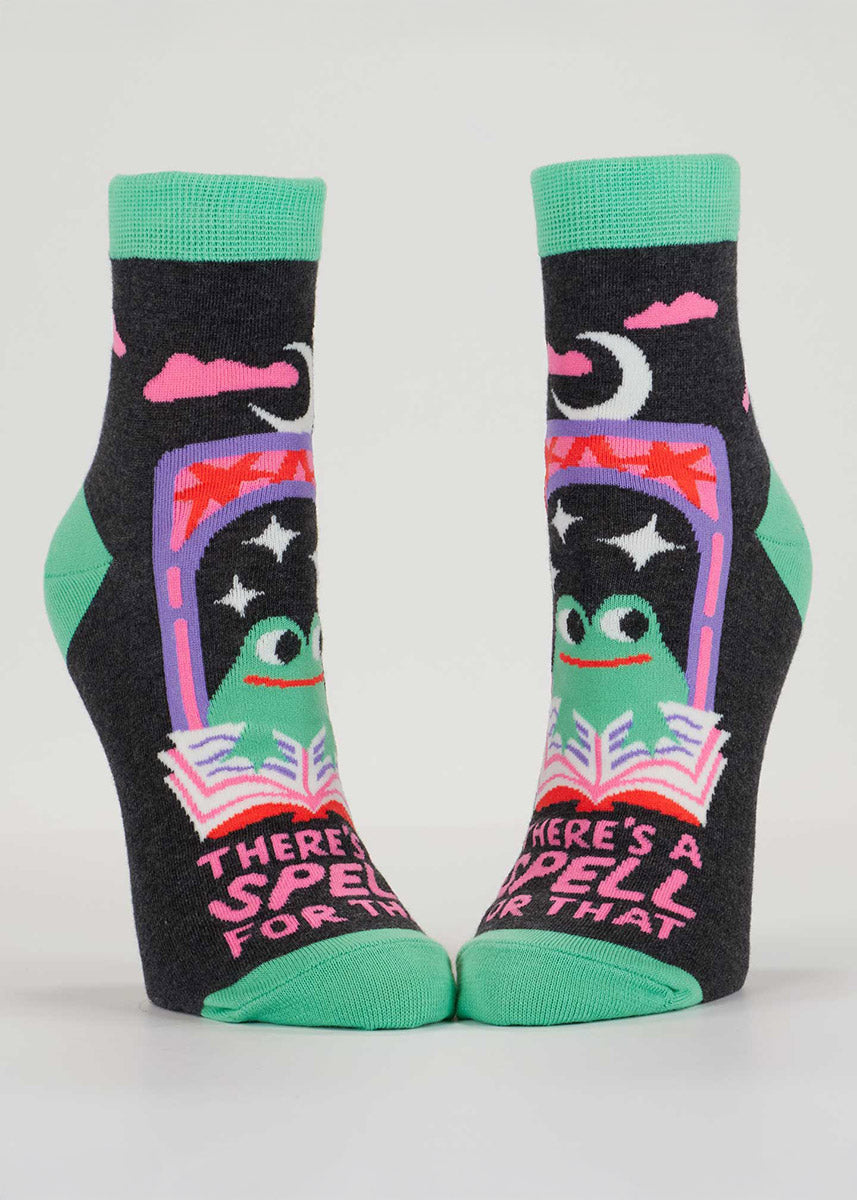 Charcoal gray ankle socks with the text “There’s a Spell For That,&quot; along with a design of frogs reading magic spellbooks.