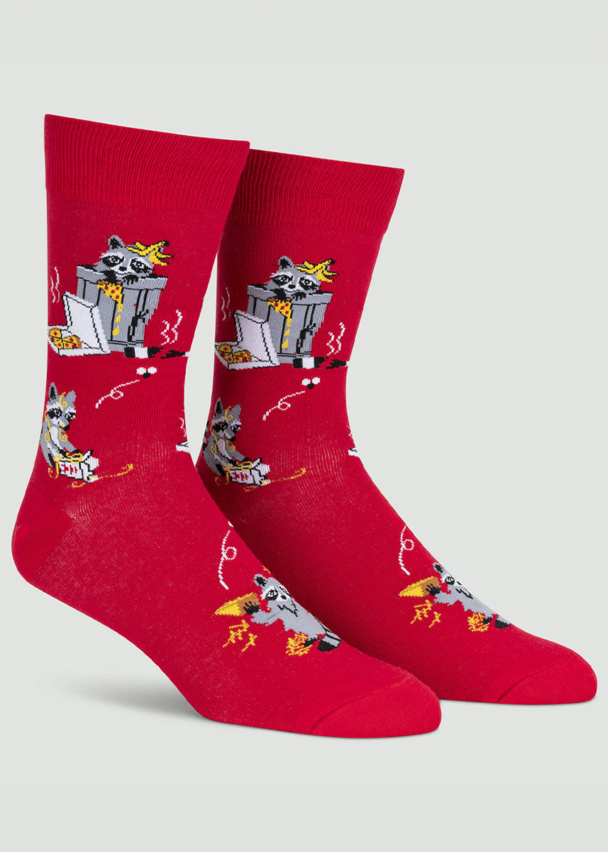Cute raccoons eat discarded pizza and takeout and play in the trash on these red men&#39;s crew socks.