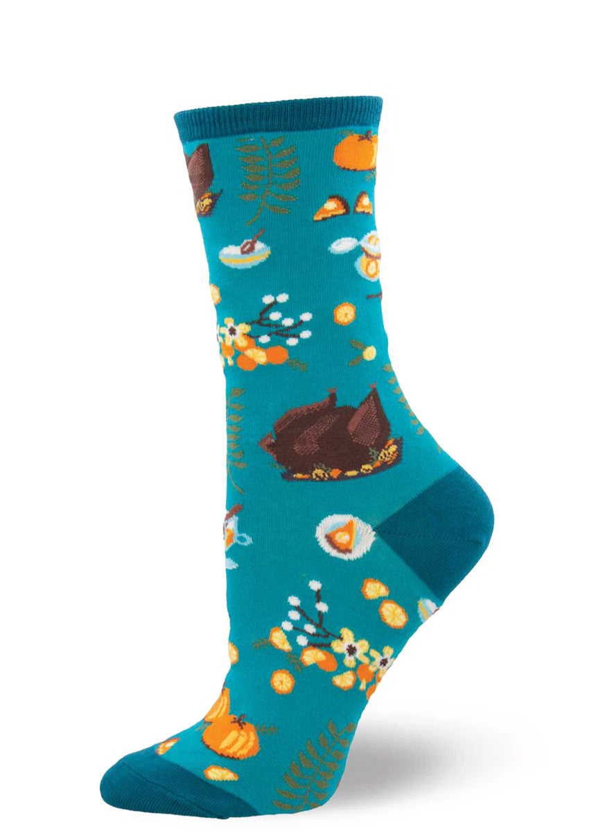 Thanksgiving socks for women show a roasted turkey, pumpkins and slices of pumpkin pie, and fall greenery.