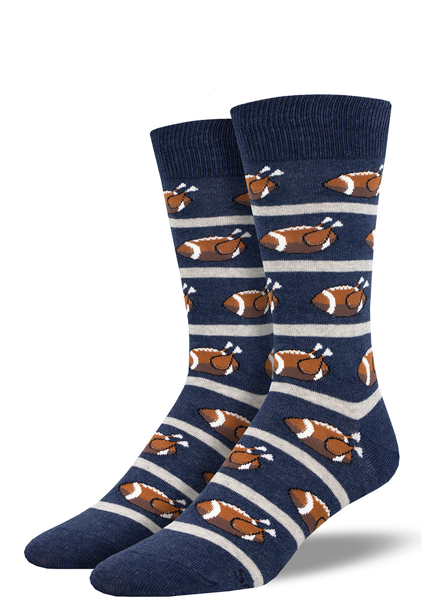 Navy and white striped socks for men featuring an allover pattern of Thanksgiving turkeys designed to look like American footballs. 