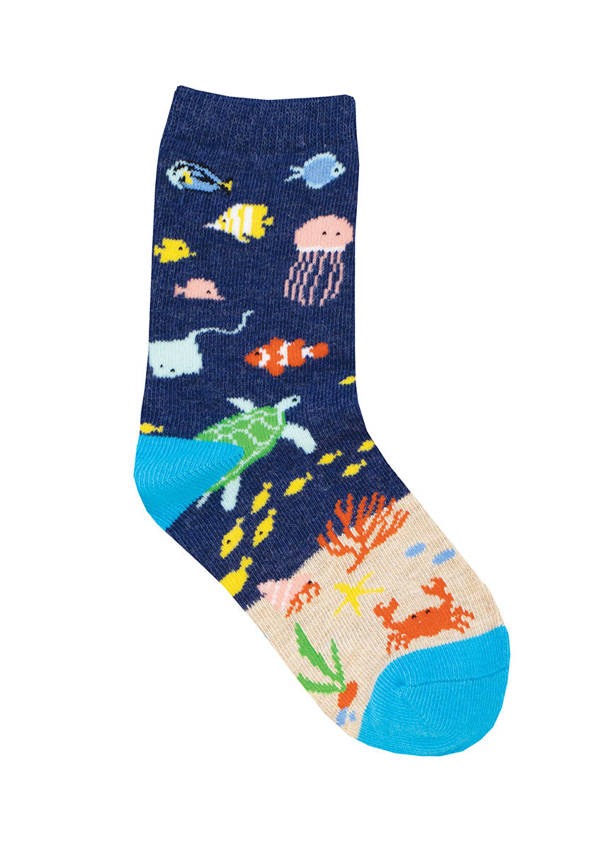 Navy crew socks for kids show an underwater scene with several sea creatures, such as a jellyfish, turtle, a crab, and more.
