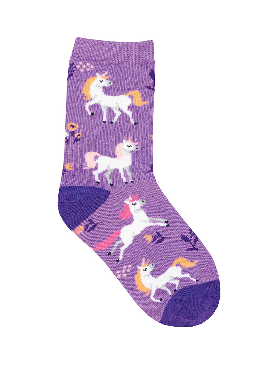 Purple crew socks for kids with a design of white unicorns with orange and pink manes, accented with small flowers throughout.