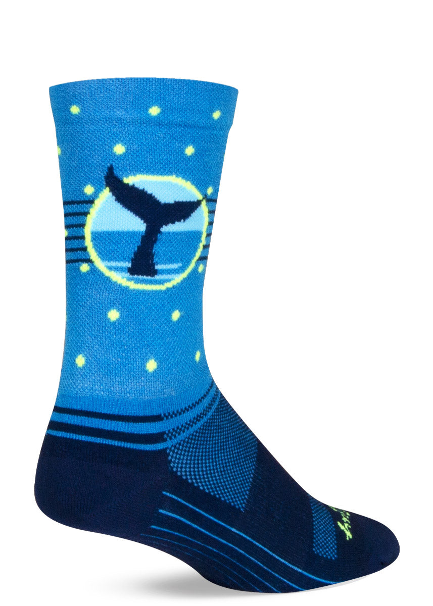 Light blue and dark blue athletic socks feature a whale tail design against a repeating pattern of polka dots.