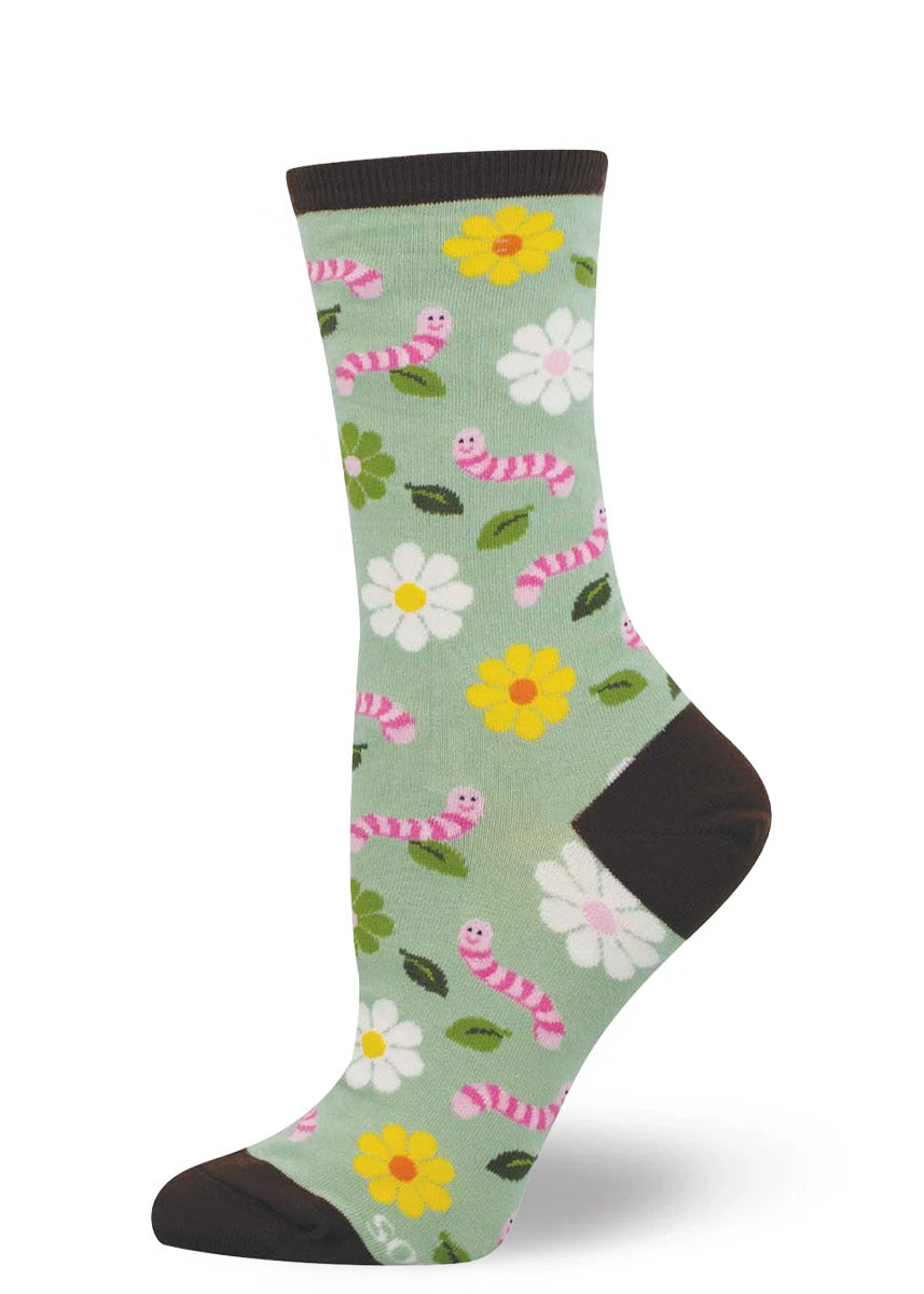 Women's crew sock with floral and earthworm pattern on a light green background.