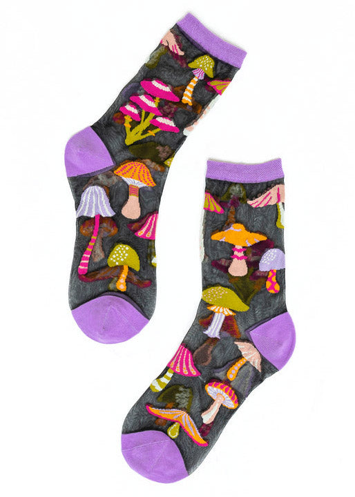 Sheer black crew socks for women with a purple toe, heel, and cuff and an allover pattern of colorful mushrooms in shades of hot pink, orange, and lime green.