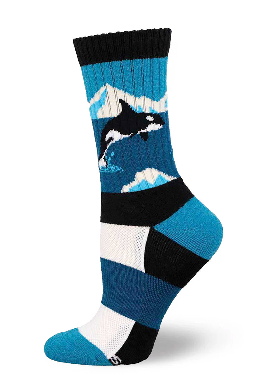 Blue and black hiking socks for women featuring an orca whale jumping out of the water against a mountain landscape.