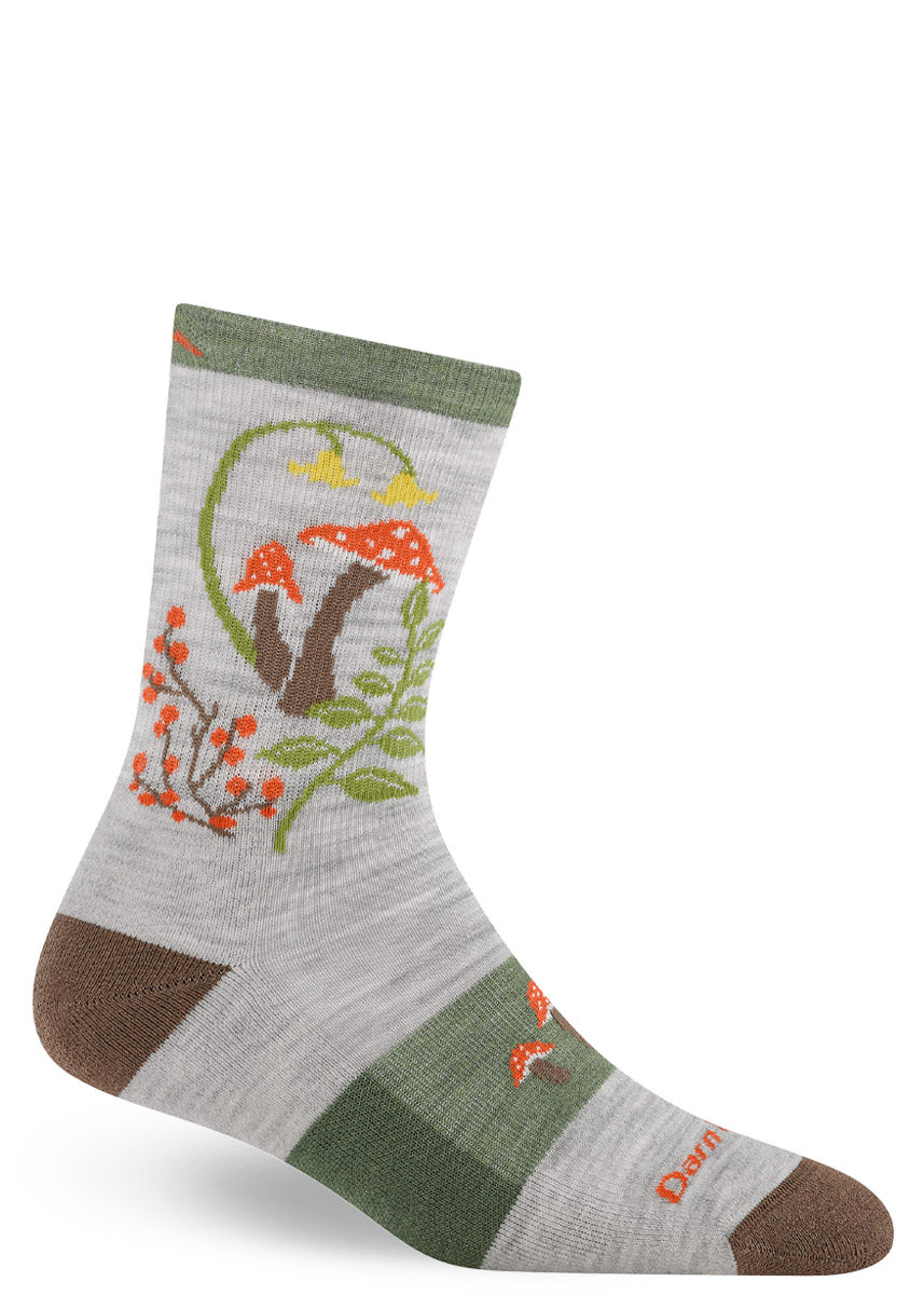 Woman's cushioned wool crew sock with mushroom and fern design on a gray background.