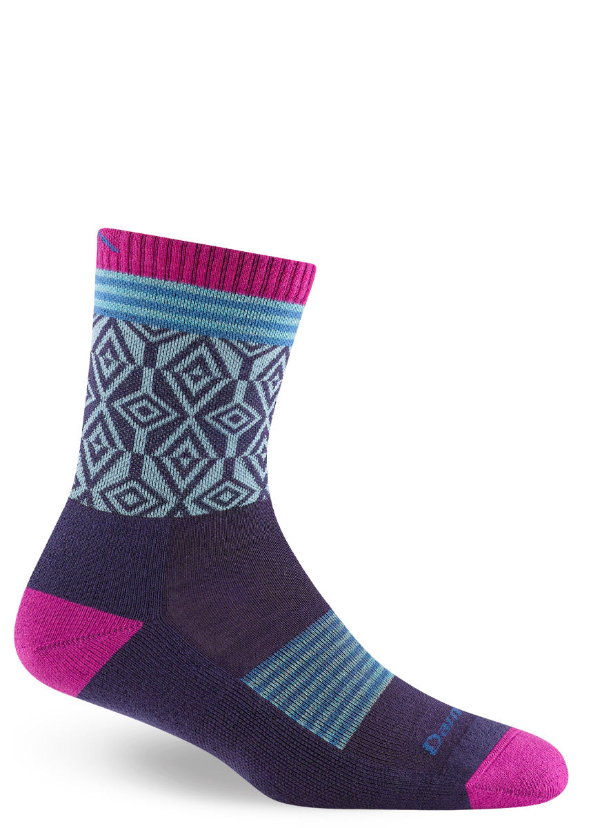 Wool hiking socks for women feature geometric patterns in light blue and dark purple with striped blue accents and hot pink cuff, toes, and heel.