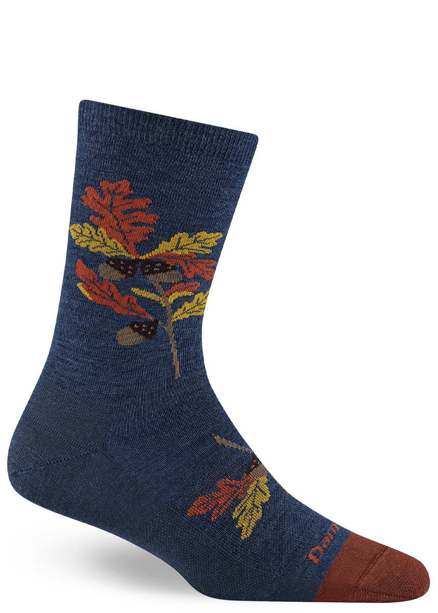 Blue crew sock with autumn leaf design on a white background.