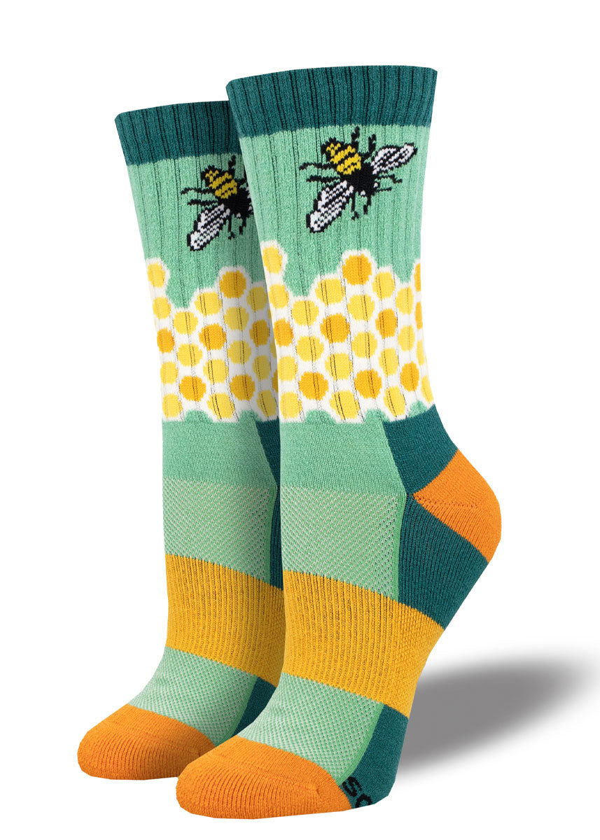 Teal, yellow, and orange wool hiking socks for women featuring a honeycomb pattern and bee design.