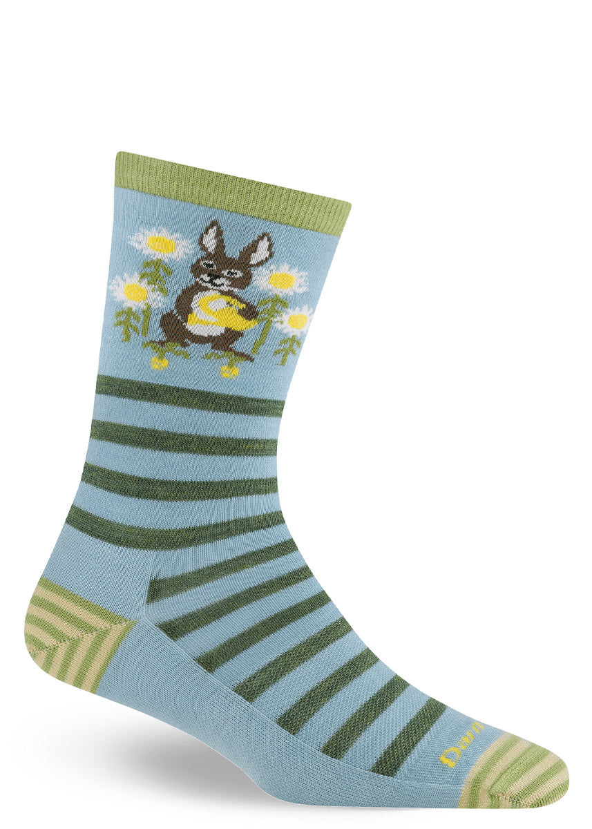 Light blue sock with green striped pattern and flower garden-themed rabbit design on a white background.