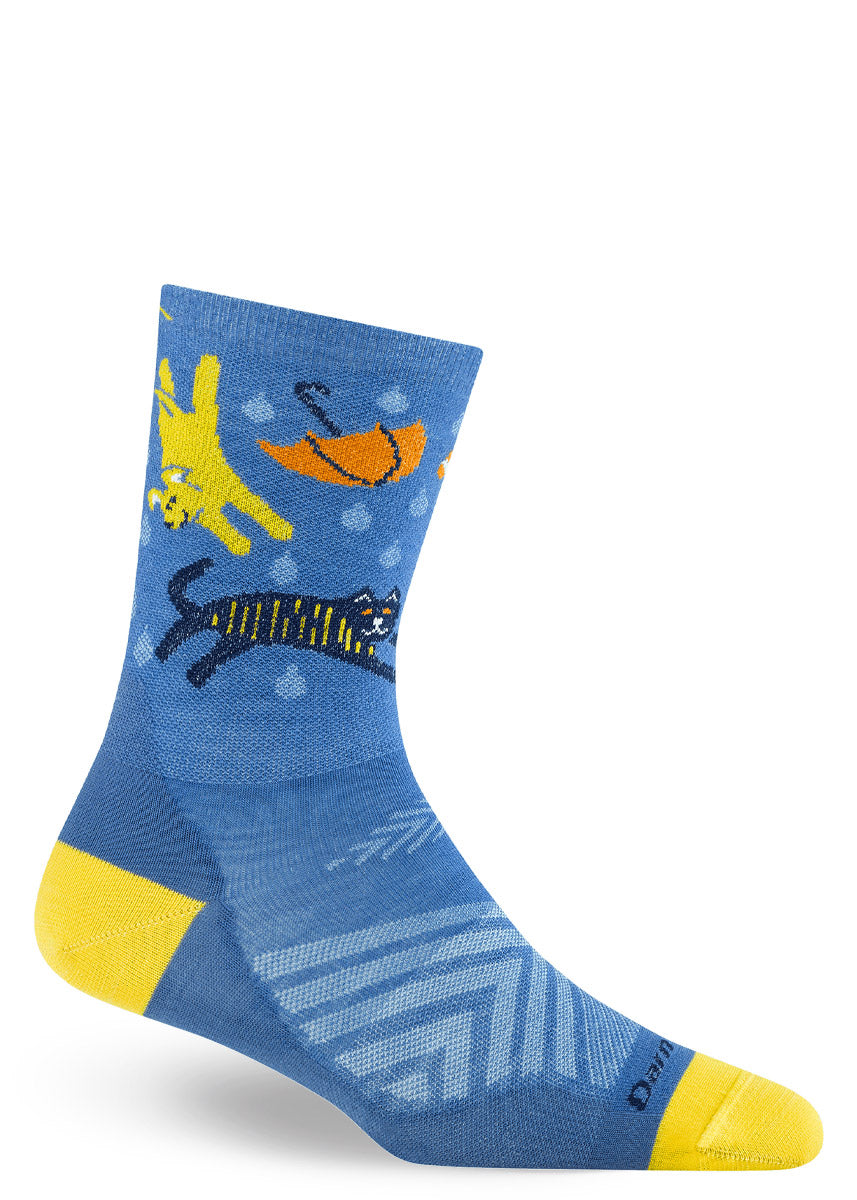 Blue crew sock with rainy-day cat and dog designs on a white background.