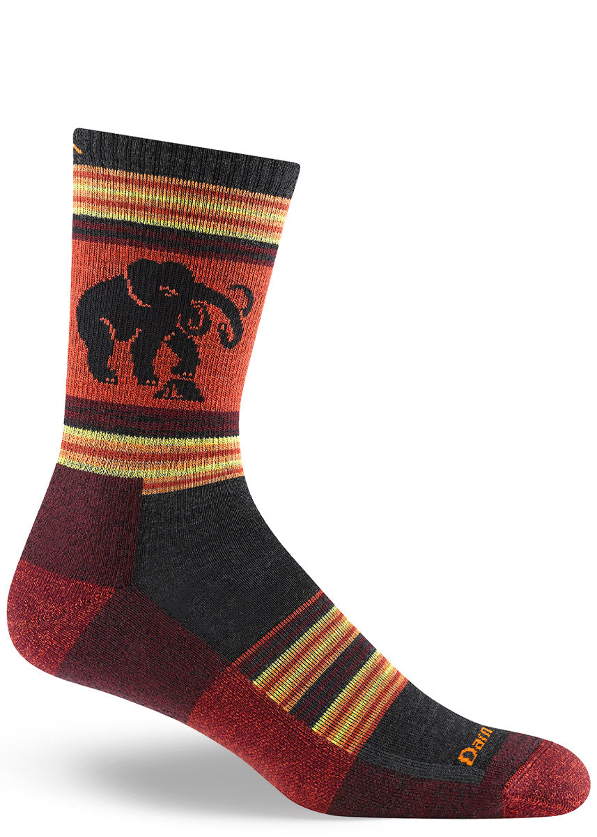Burgundy, red-orange and charcoal merino wool hiking socks for men in a multicolor design that depicts a woolly mammoth.