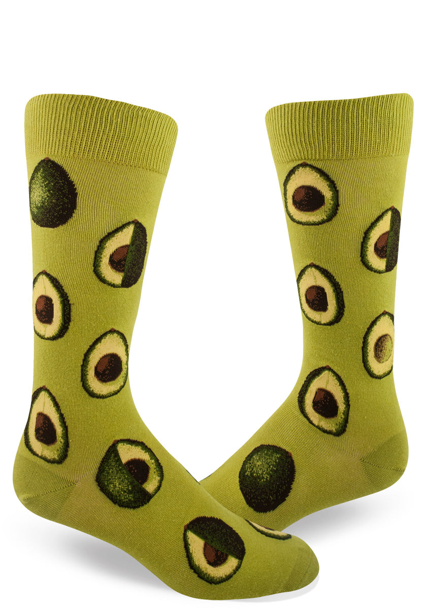 Avocado socks for men with avocados sliced in half on a green background