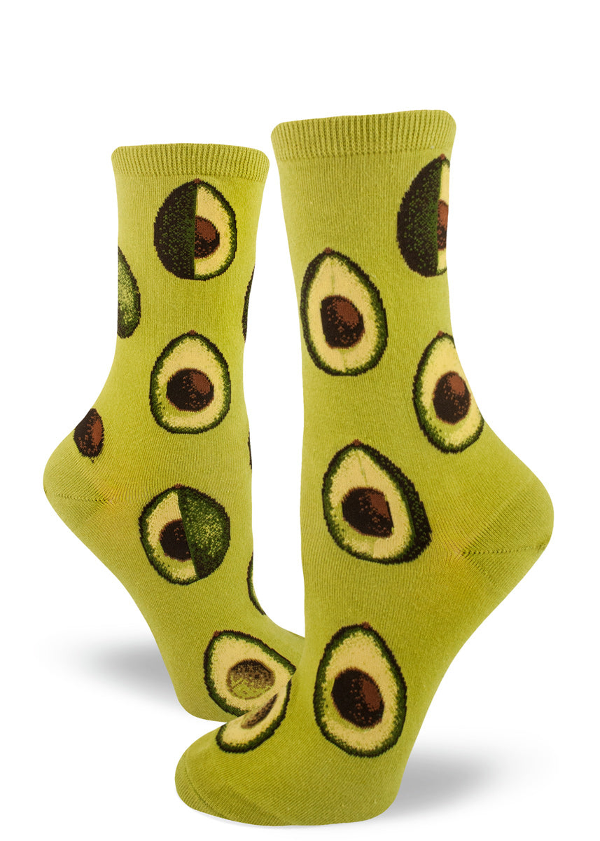 Cute avocado socks for women with avocados sliced open on a green background