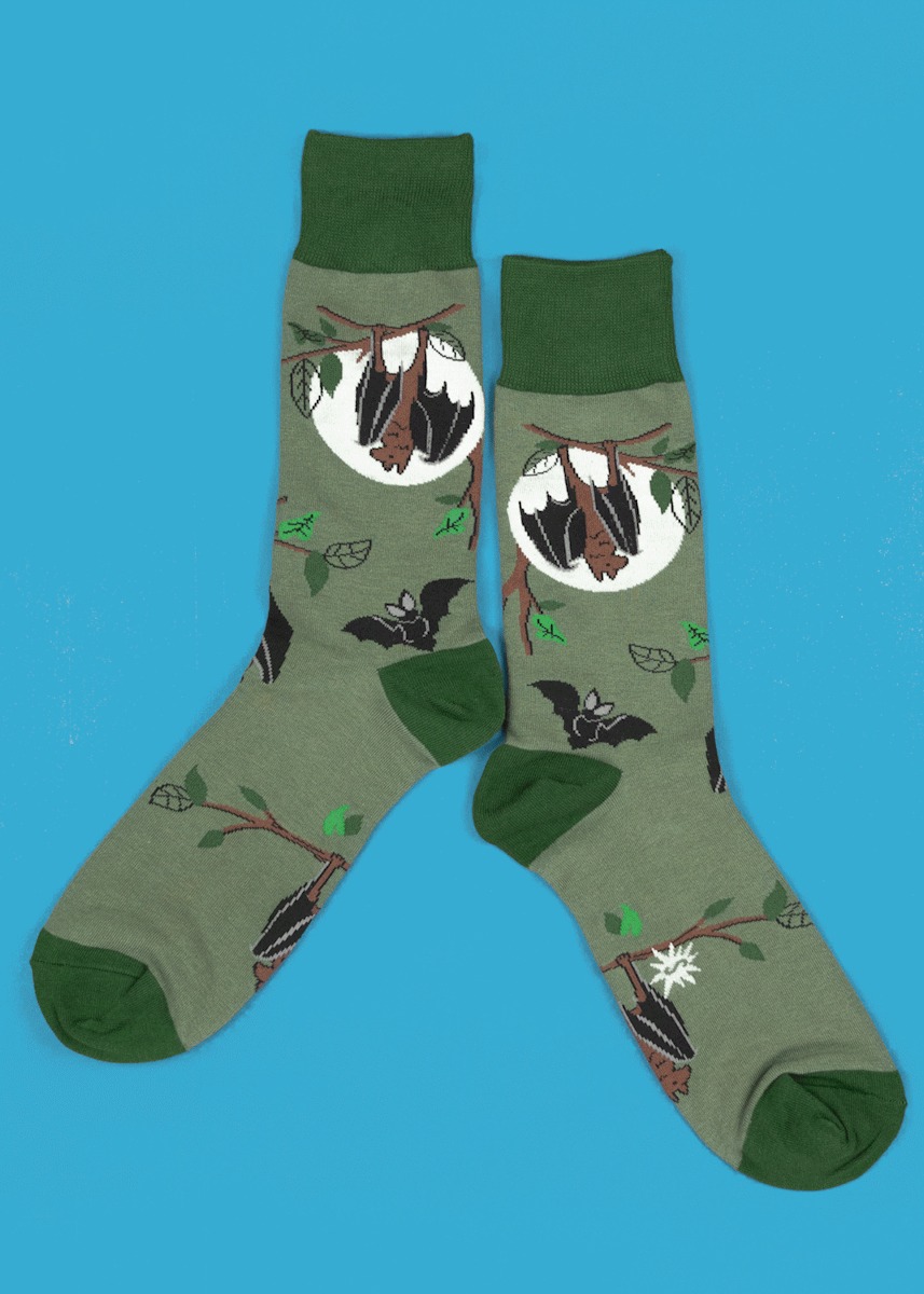 Crew socks for men feature bats hanging upside down in front of a glow-in-the-dark moon.