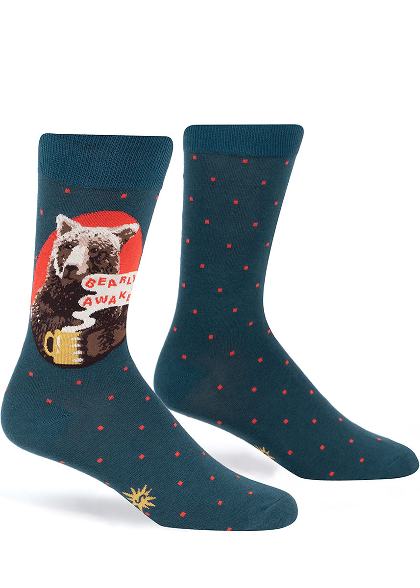Funny crew socks for men show a grizzly bear with a mug of coffee and the words, &quot;Bearly Awake.&quot;
