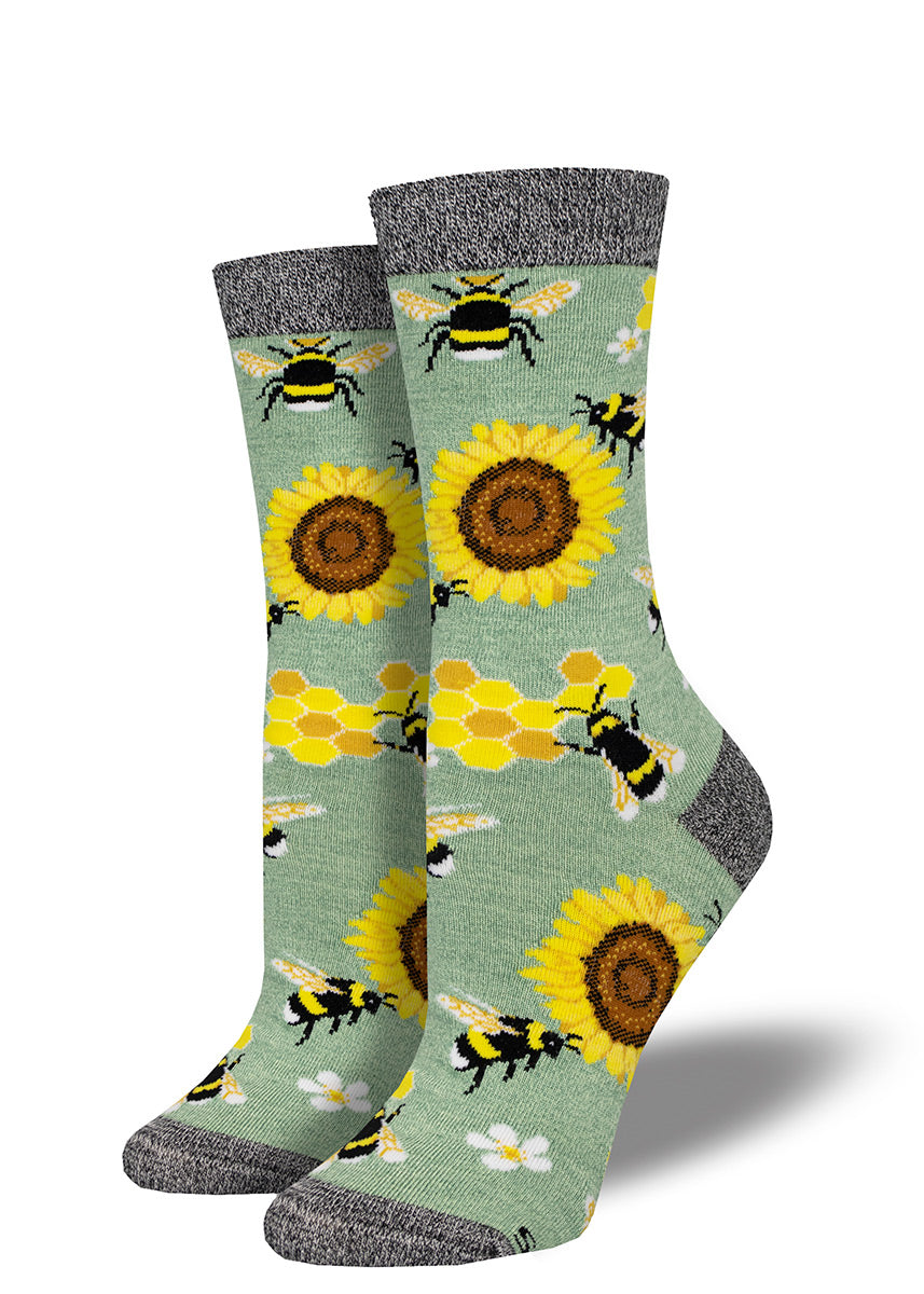 Green bamboo crew socks with a design of golden sunflowers, honeycomb and bumblebees.
