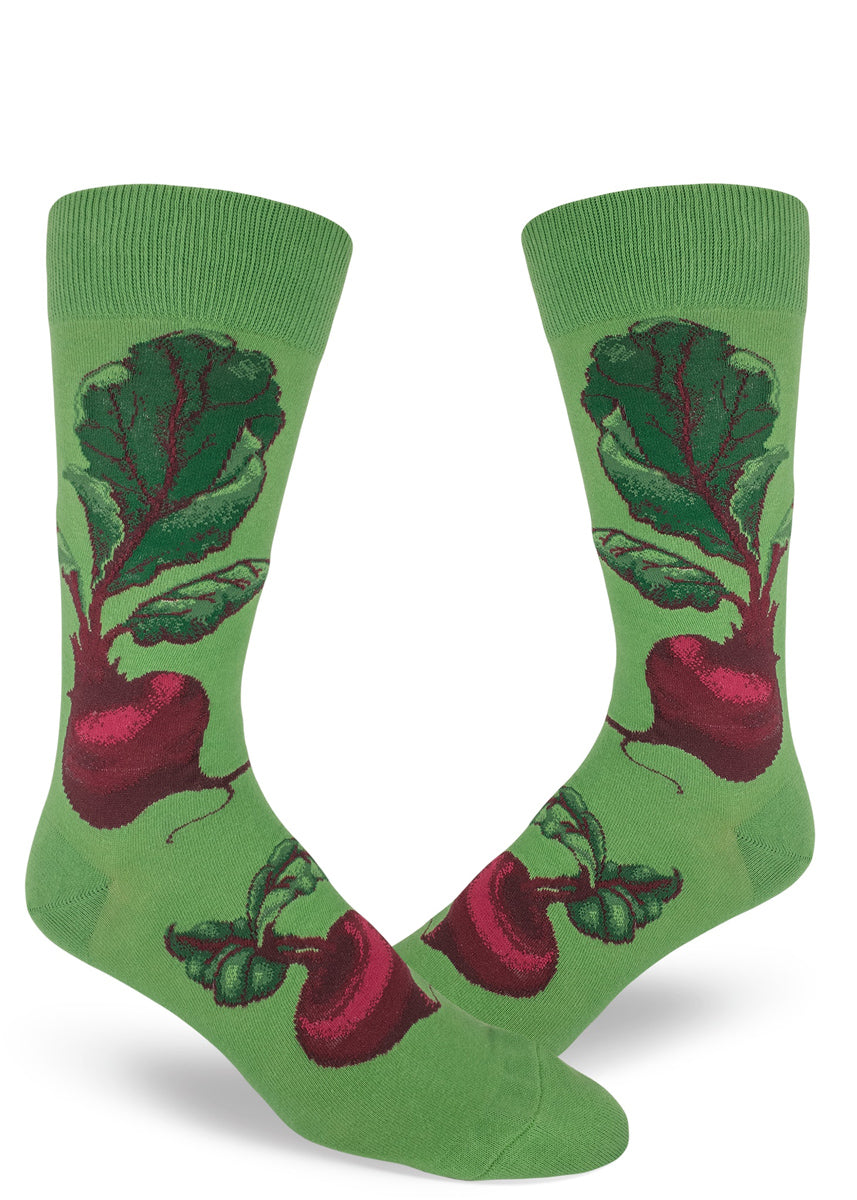 Beet socks for men with red beets and their leaves on a green background.