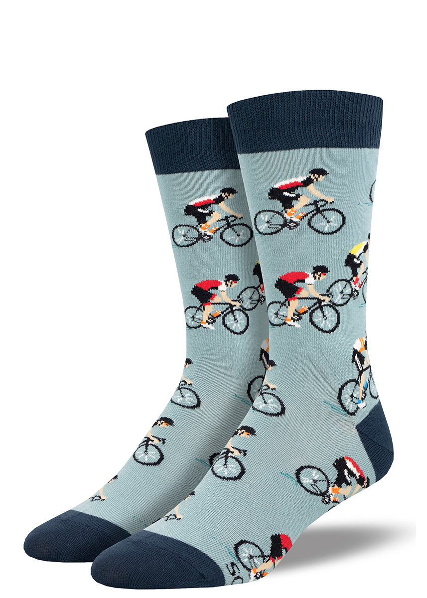 Light blue novelty crew socks for men with a pattern of road cyclists wearing various multicolor cycling kits.
