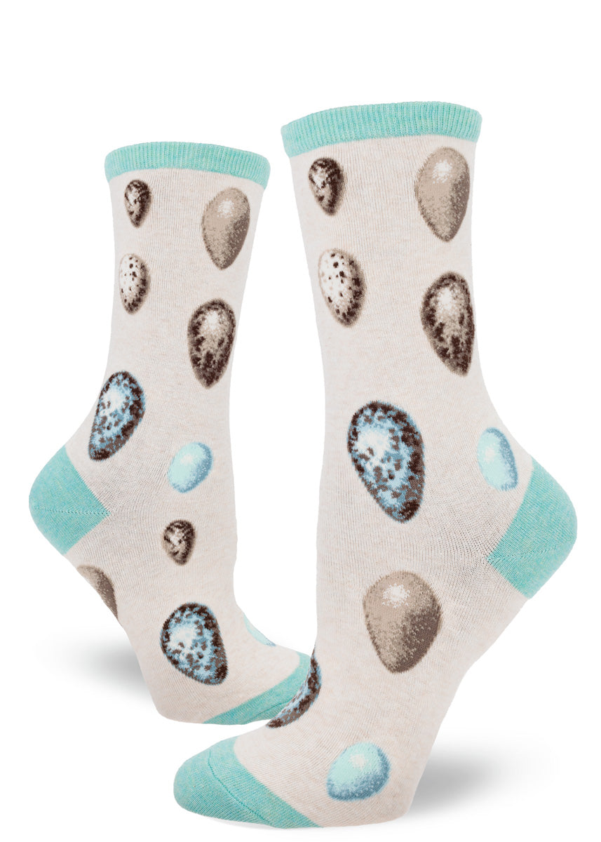 Novelty socks with a pattern of natural bird eggs in shades of aqua and brown over a cream background.