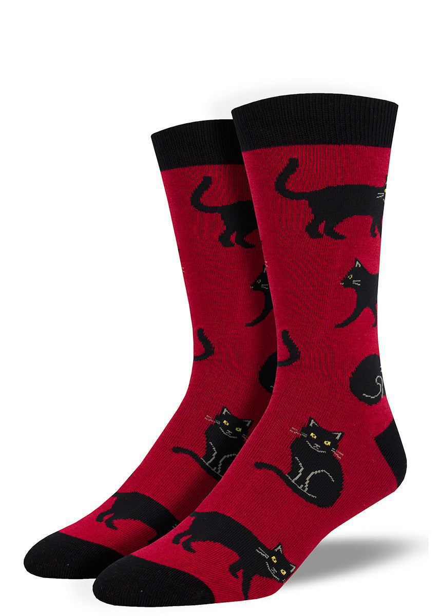 Black cat socks for men with cats with yellow eyes on a dark red background