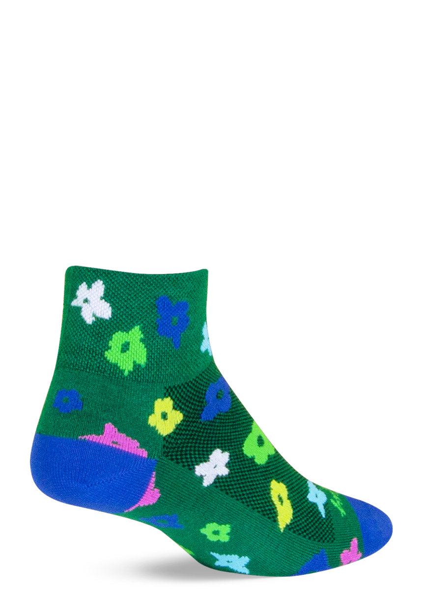 Green ankle athletic socks with a floral pattern of abstract daisies in yellow, blue, white, bright green and pink. 