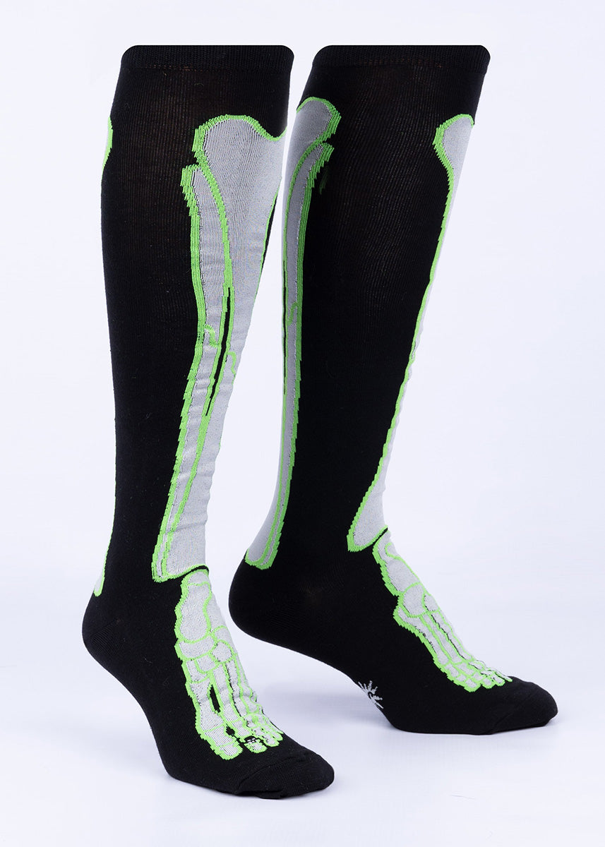 Black knee socks depicting the tibia, fibula and small bones of the foot with glow-in-the-dark green outlines.
