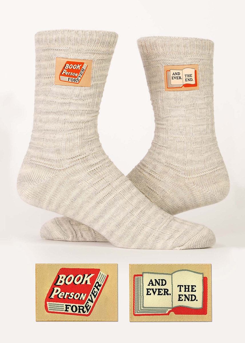 Heather oatmeal organic cotton socks knit with a textural basket weave pattern and embellished with small decorative stitched-on tags that proudly proclaim “Book Person Forever/And Ever. The end.”