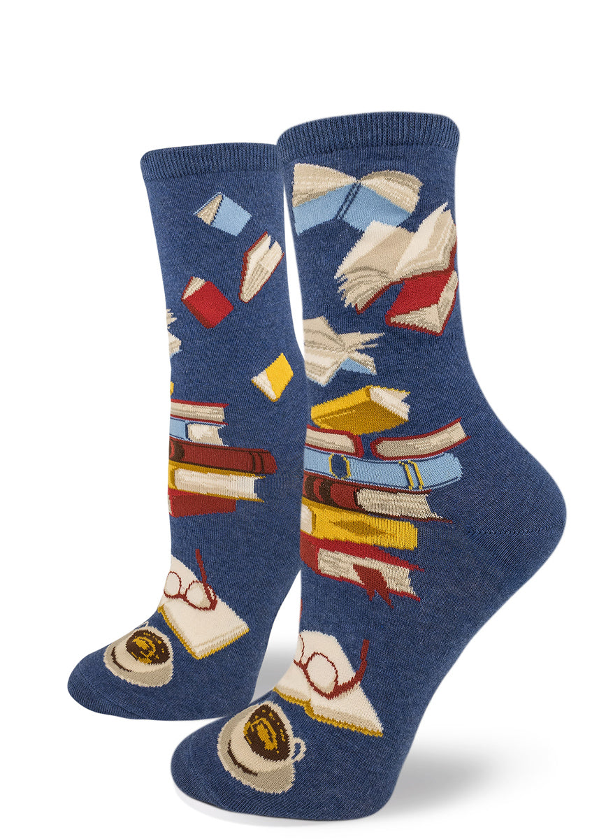 Women&#39;s book socks with piles of books, a book being read and flying books on a blue background