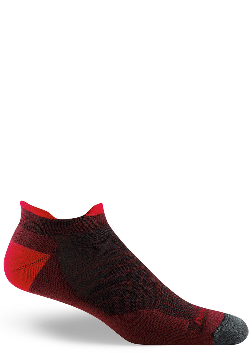 Wool running socks for men feature a lightly cushioned ankle-length design of burgundy, red, and charcoal.
