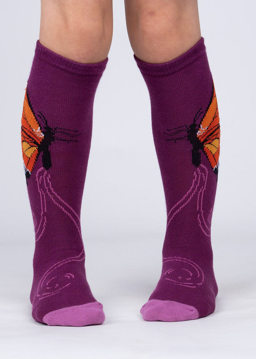 Butterfly knee high socks for kids feature orange Monarch butterflies on a purple background!