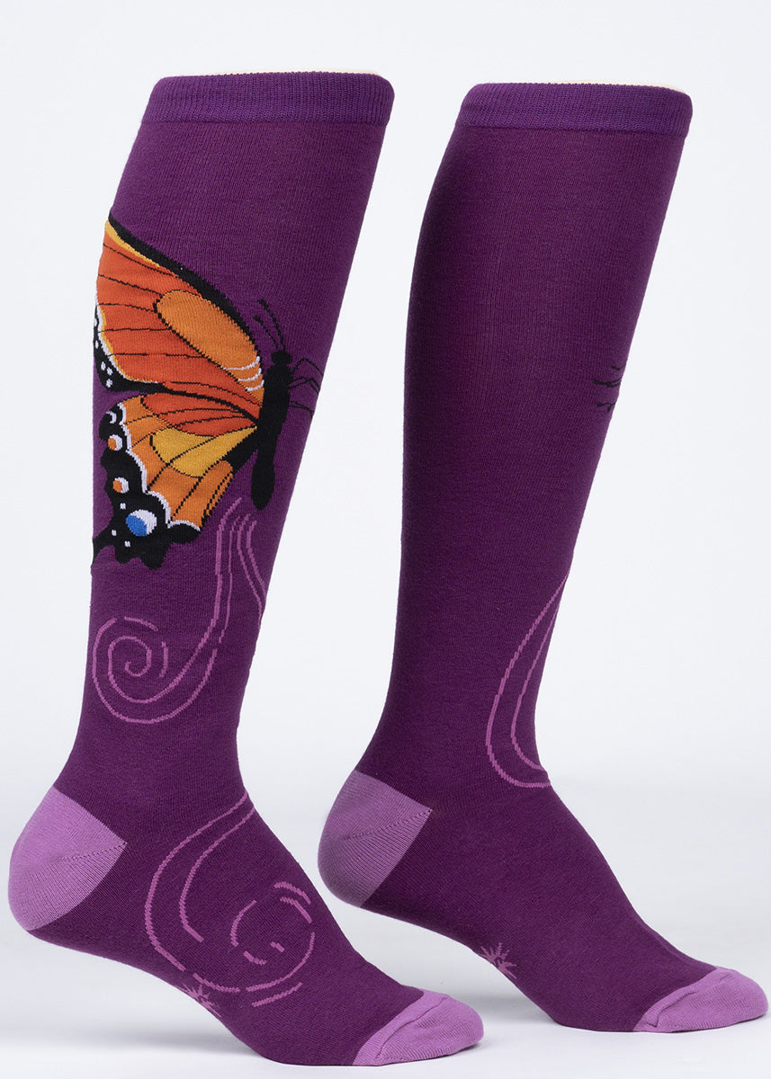Knee-high socks feature a gorgeous orange Monarch butterfly on a purple background.