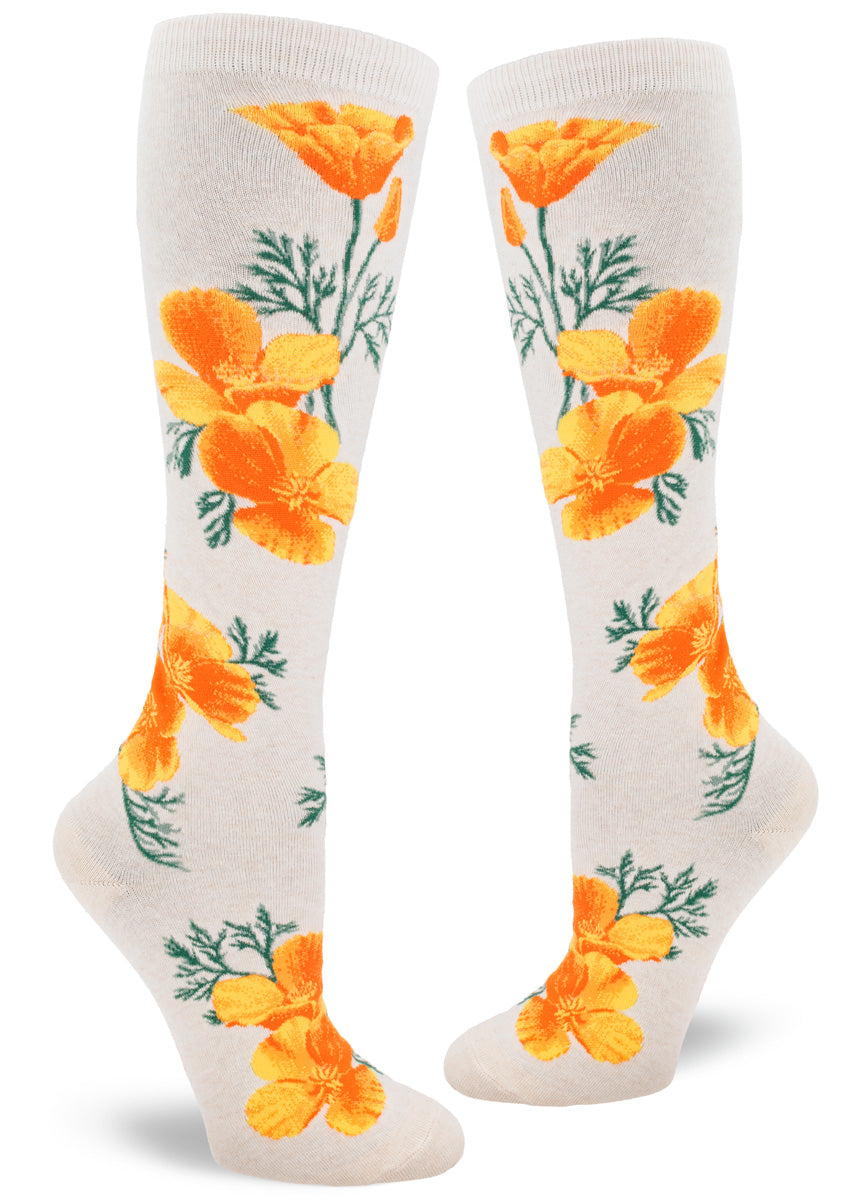 California poppy flower knee socks show off the bright orange blooms and their feathery green foliage on a cream background.