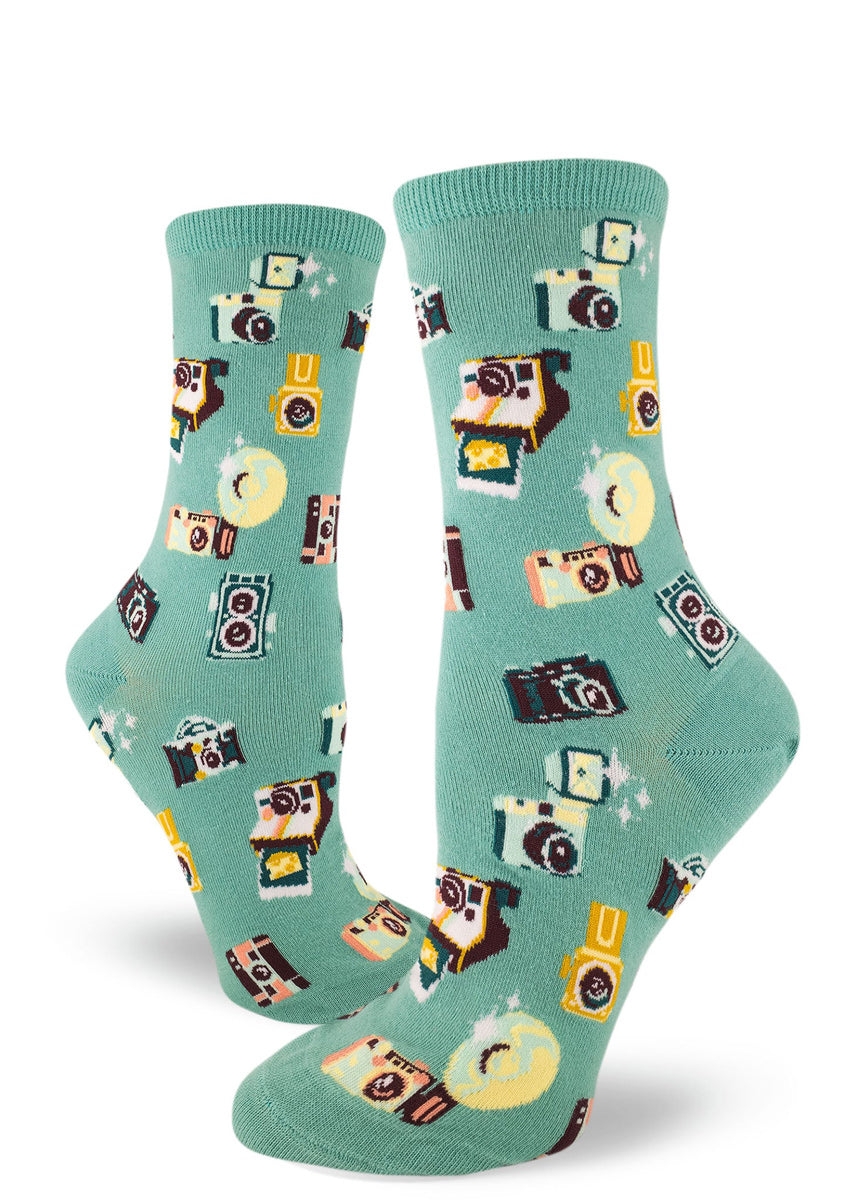 Cute camera socks for women with vintage cameras flashing and printing Polaroids on dusty turquoise background