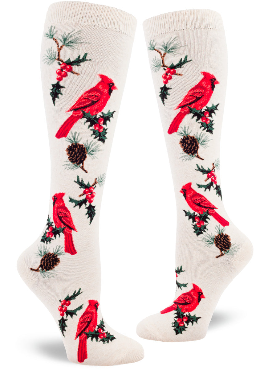 Cardinal knee socks feature the bright red bird perched among pine branches and holly sprigs.