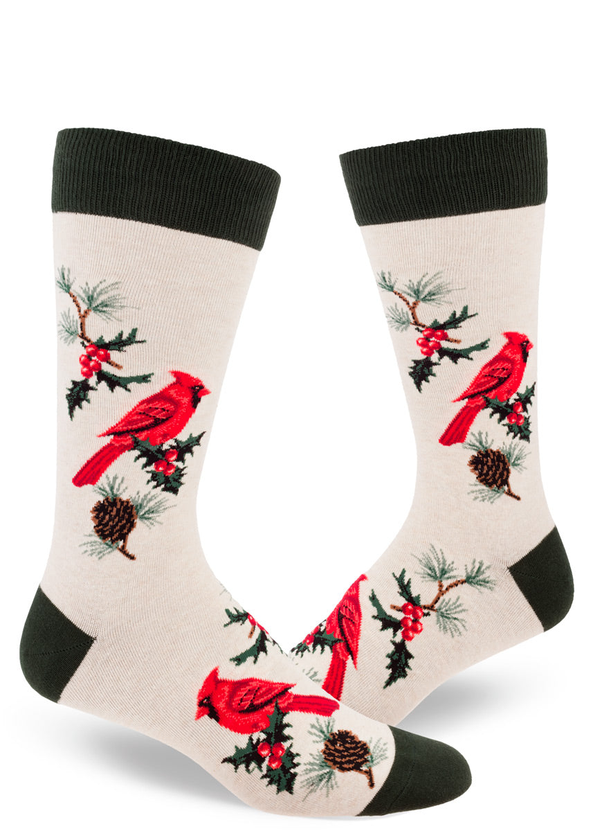 Festive winter crew socks for men feature bright red cardinals perched on pine branches with holly sprigs.