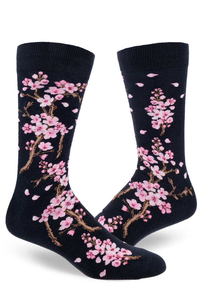 Spring crew socks for men feature pale pink cherry blossoms on a deep navy background.