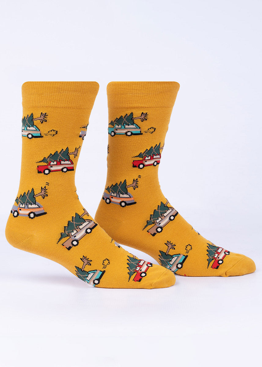 Gold men&#39;s crew socks with a pattern of multicolored vintage cars, each with a huge Christmas tree strapped to the top.