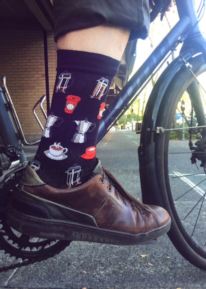 Coffee socks for men with coffee cups and French presses on a black background