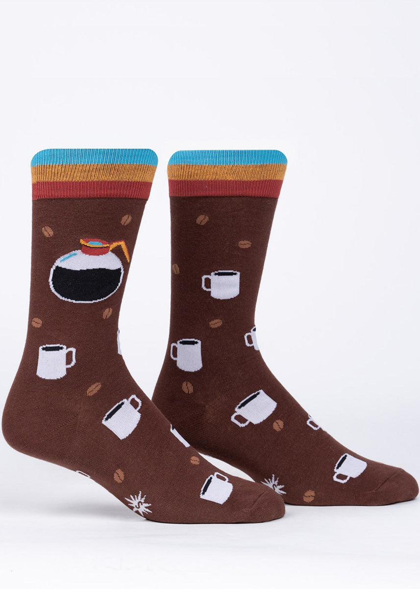 Coffee socks for men feature pots of fresh coffee, classic white mugs, and little coffee beans on a dark brown background.