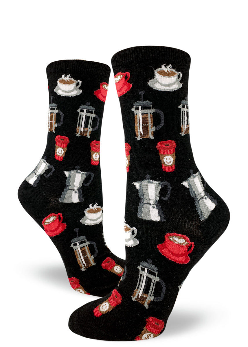 Coffee socks for women with French press coffee pots, cups of coffee and to-go cups of coffee on a black background