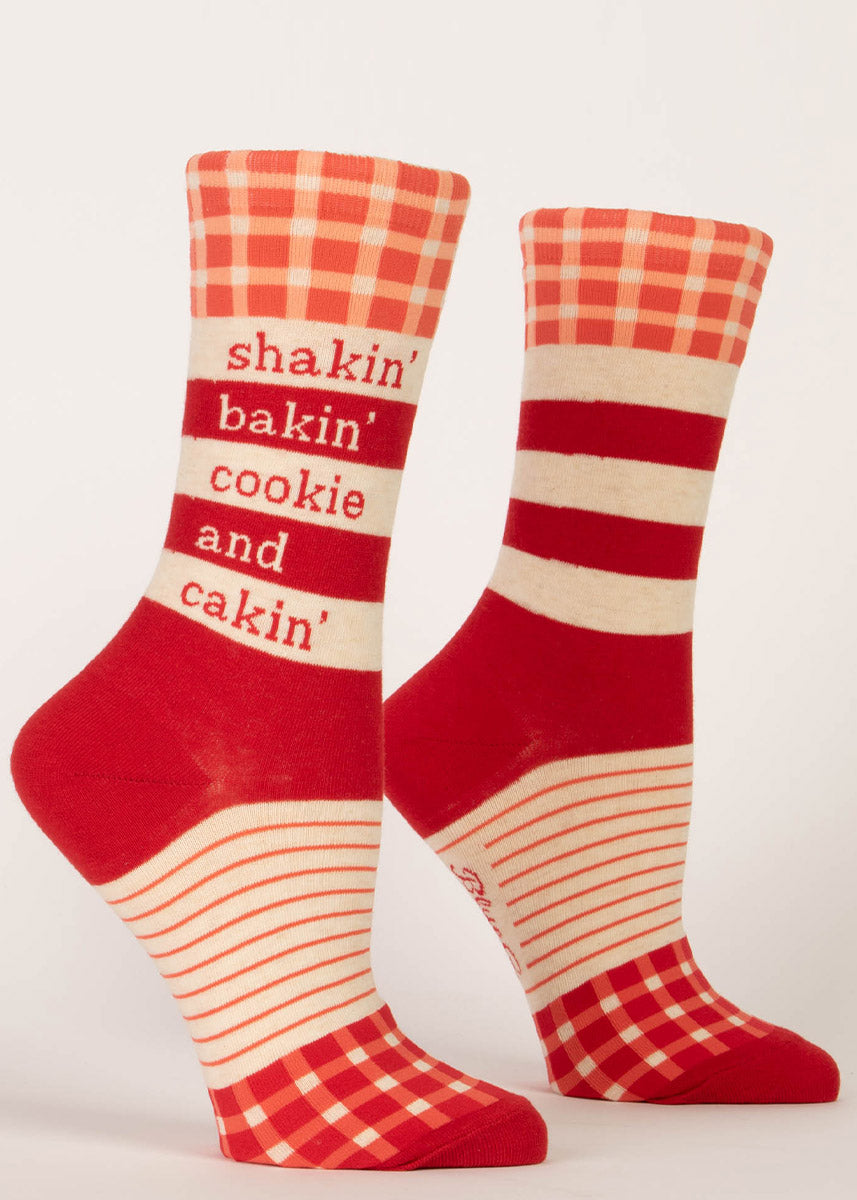 Cute crew socks have a red gingham and stripe pattern with the words “Shakin&#39; bakin&#39; cookie and cakin&#39;” on the leg.